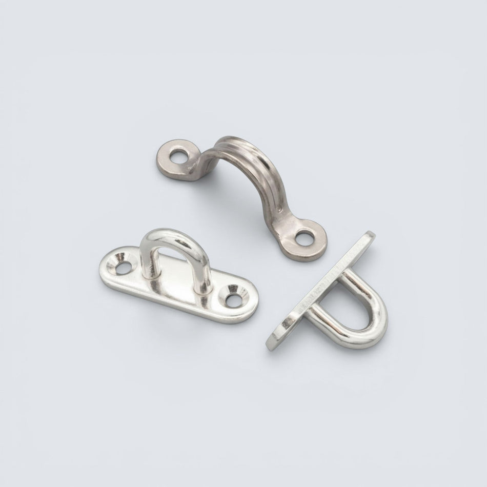 Bild på byglar och öglefästen i rostfritt stål mot grå bakgrund.