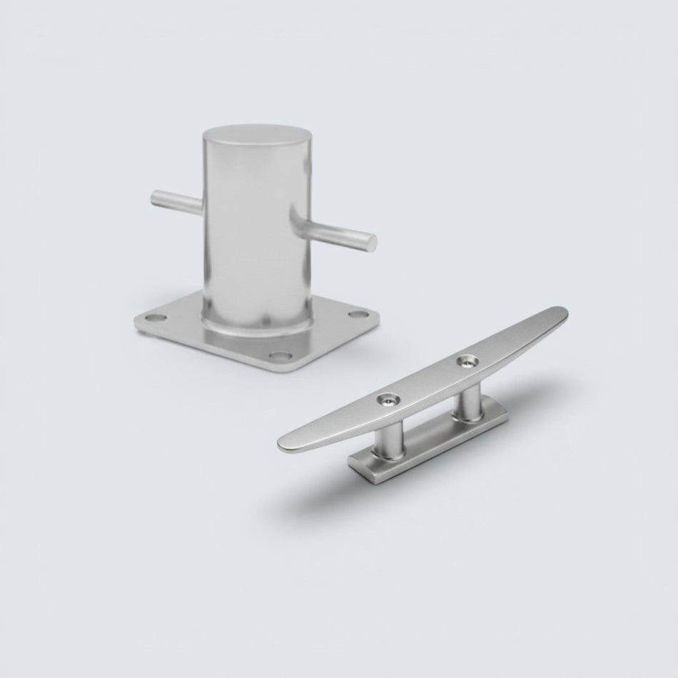 Bild på en knap och pollare i rostfritt stål mor en grå bakgrund.